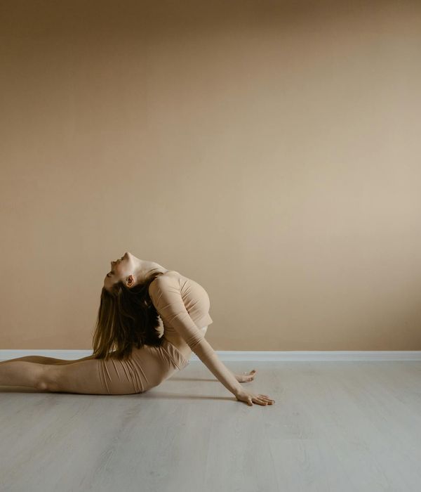 Woman in a calm yoga pose, embodying flexibility and grace.
